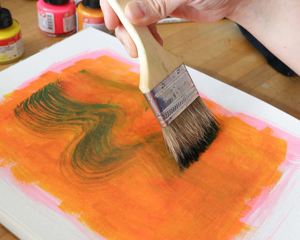 Esther Nariyoshi drawing by hand at her desk with art supplies, the process behind each postcard
