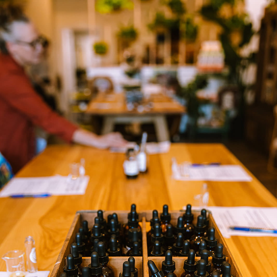 Wooden crate of bottles labeled 'towne club beverages' on a table with blurred background