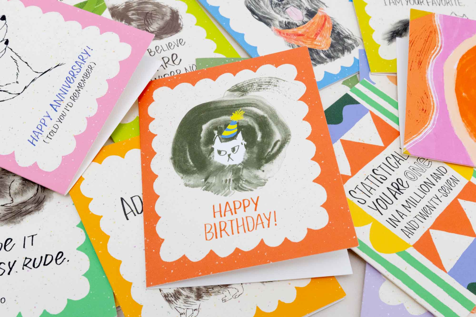 Collection of colorful greeting cards with various designs and text.