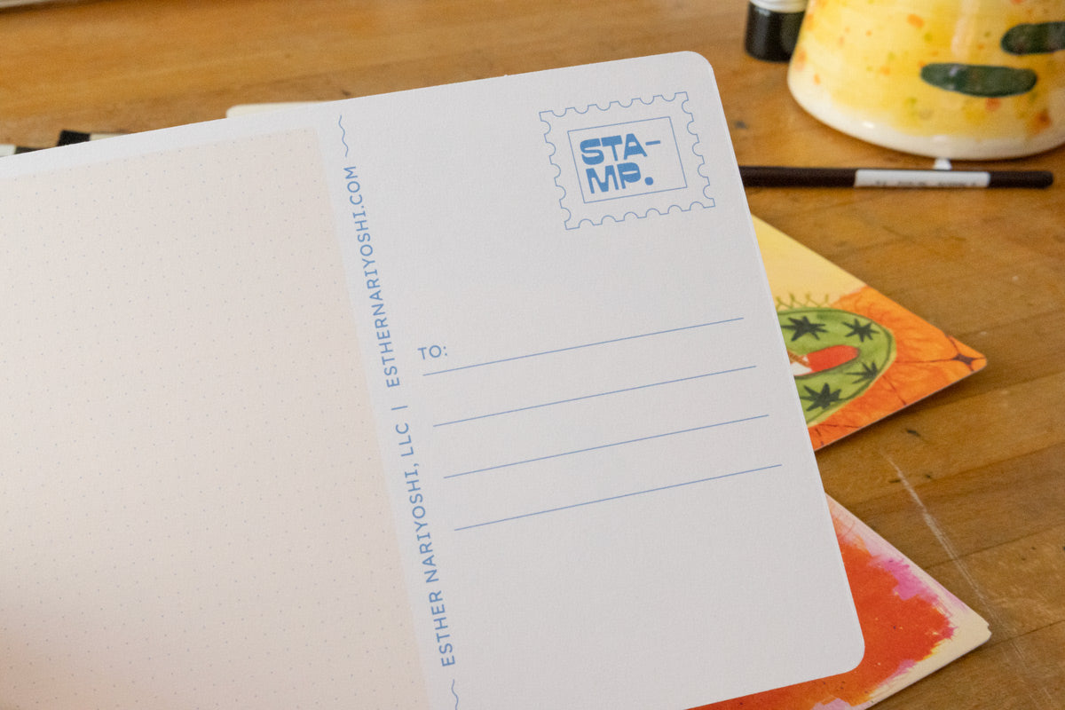Back of an illustrated postcard with a dot grid writing area and stamp box